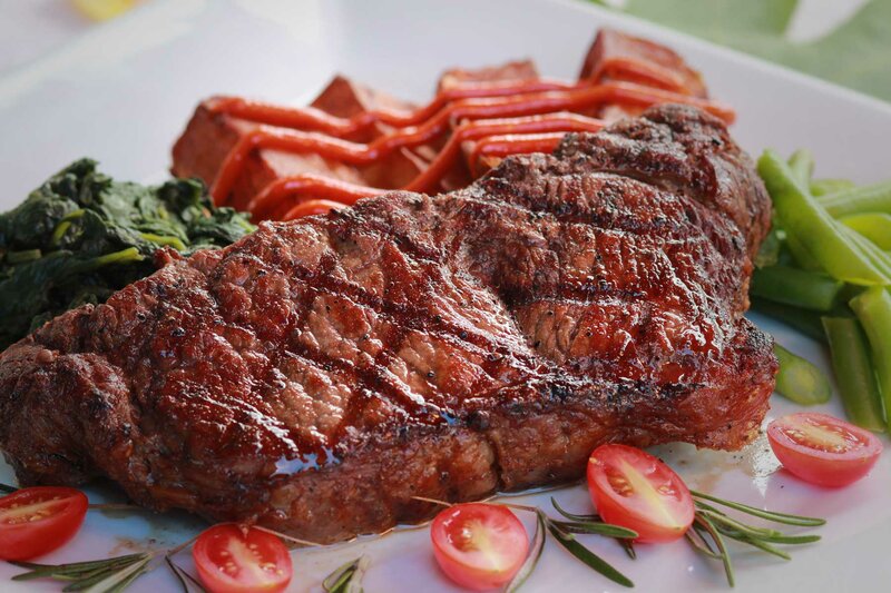 Steak entree with various vegetables