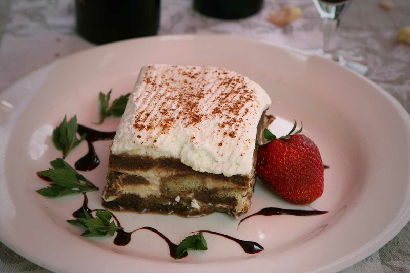 Cake dessert topped with icing a strawberry