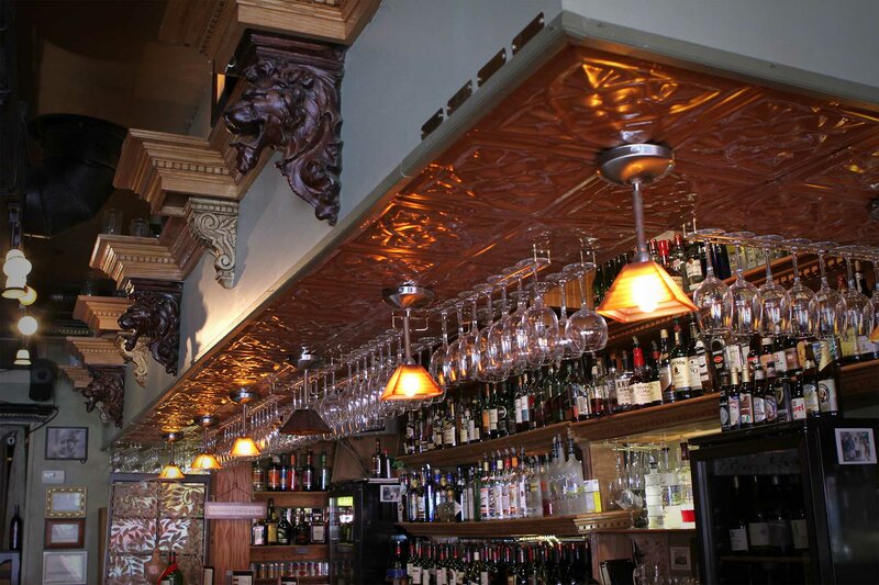 Bar area with wine glasses hanging from the ceiling